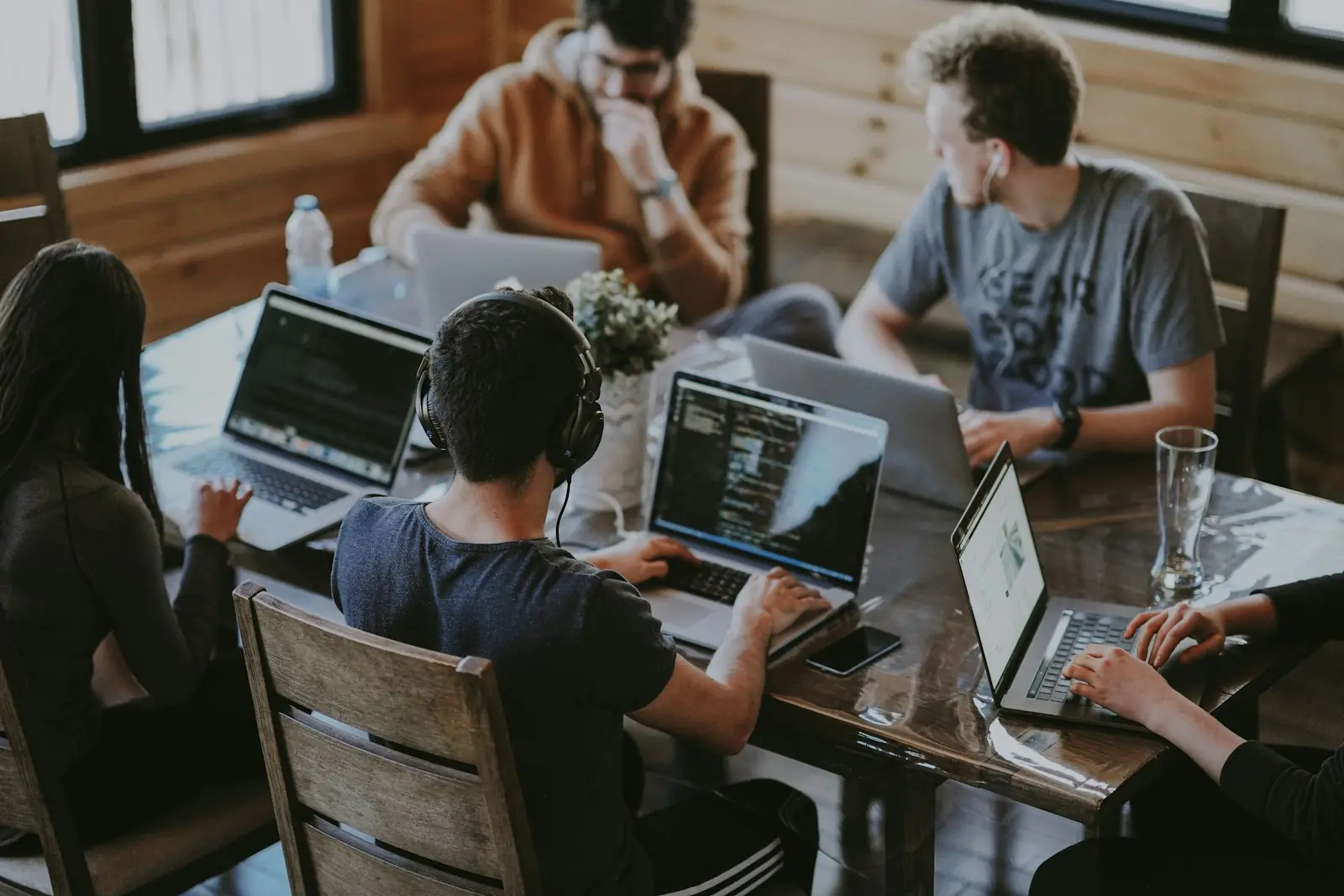 A small team working side by side on laptops around one table